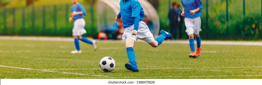 Kids Play Soccer Game. Children Outdoor Football Tournament Match On Grass Field