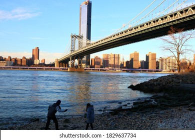 Kids Play Stone Skipping On Brooklyn Waterfront