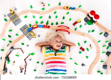 Kids Play With Toy Train Railway. Child Playing With Wooden Trains. Toys For Little Boy. Preschooler Building Rail Road And Blocks At Home Or Daycare, Preschool. Kindergarten Educational Games.