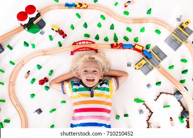 Kids Play With Toy Train Railway. Child Playing With Wooden Trains. Toys For Little Boy. Preschooler Building Rail Road And Blocks At Home Or Daycare, Preschool. Kindergarten Educational Games.