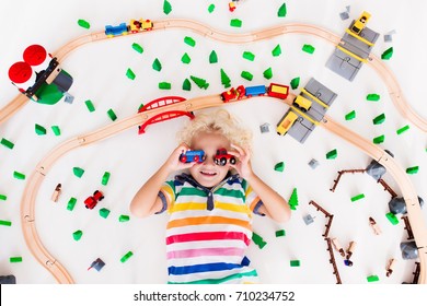 Kids Play With Toy Train Railway. Child Playing With Wooden Trains. Toys For Little Boy. Preschooler Building Rail Road And Blocks At Home Or Daycare, Preschool. Kindergarten Educational Games.