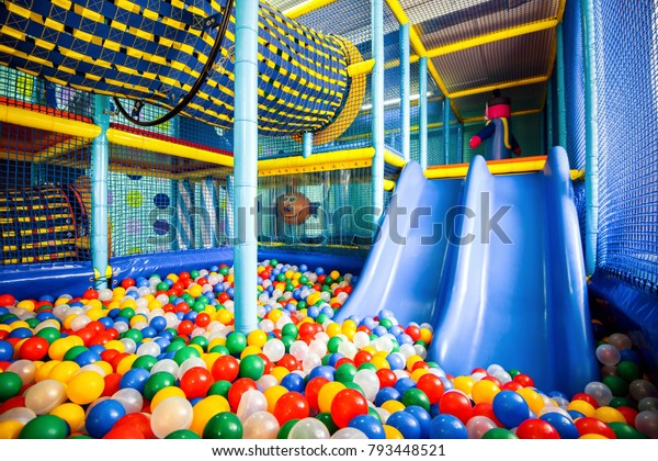 Kids playground indoor, inside big colorful\
plastic structure for active game, play and recreation. Dry pool,\
ball pit and slide. Children\'s playground, gym in kindergarten.\
Soft ground, jungle indoor