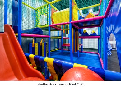 Kids Playground Indoor, Inside Plastic Jungle For Playing And Development Of Motor Skills. Children's Gym With Slide And Maze In Kindergarten Indoor. Modern Soft Playground In Playroom.