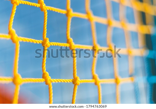 Kids Playground Safety Color Net. Texture of\
yhe Mesh Fence on the\
Playground