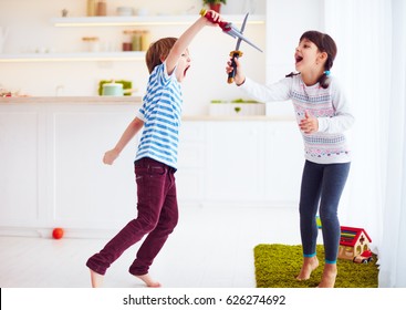 kids playing active fight games at home kitchen