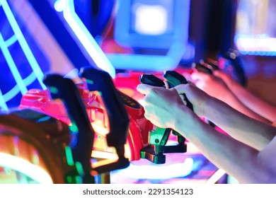 Kids playing arcade video games. Close up of details double hands controlling joystick.