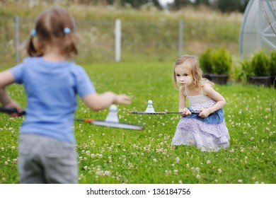 Kids playing badminton on beautiful summer day
