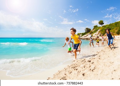 Kids Playing Catch-up On Sandy Beach