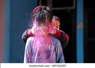 Kids Playing With Color At Home During Holi Festival Of Colors