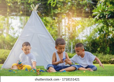 Kids Playing With Colorful Toys At A White Tent On Playground Home Backyard