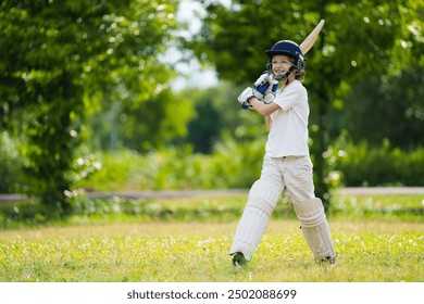 Kids playing cricket in summer park. Boy with bat and ball on cricket pitch. Helmet and guard for safe game. Sport for active child. Cricket club for school children. Sports activity and exercise. - Powered by Shutterstock