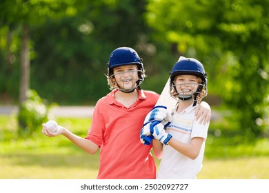 Kids playing cricket in summer park. Boy with bat and ball on cricket pitch. Helmet and guard for safe game. Sport for active child. Cricket club for school children. Sports activity and exercise. - Powered by Shutterstock