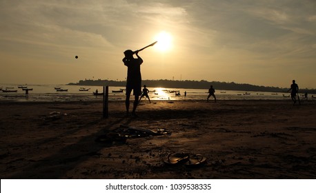 Kids Playing Cricket At The Time Of Sunset On A Beach In Mumbai