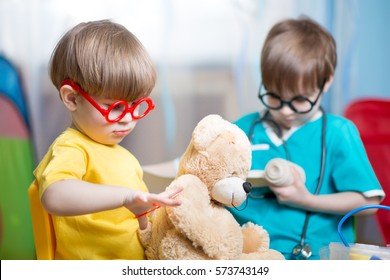 Kids playing doctor and curing plush toy at home