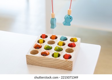 Kids Are Playing And Finding The Matched Number In The Wooden Magnetic Fishing Game, Using Wooden Fishing Pole Provided With Magnets To Attach The Mouth Of The Fish And Picking It Up.