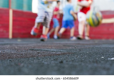 Kids Playing Football At School Playground