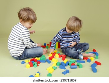 Kids Playing A Game With Blocks, Sharing, Getting Along, And Teamwork Concepts