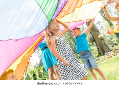 Kids Playing In Games On A Birthday Garden Party