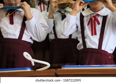 Kids Playing Harmonica Together At Kindergarten Recital