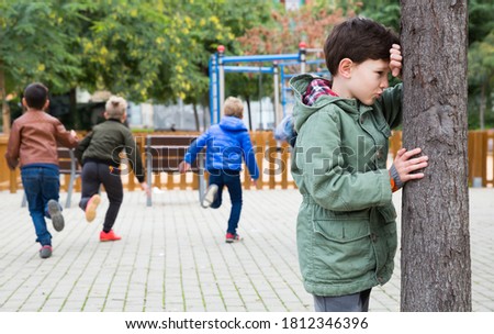 Kids playing hide and seek on the street. High quality photo