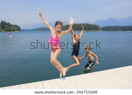 Kids playing at the lake on their summer vacation 