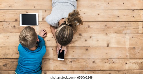 Kids Playing With Mobile Phone And Tablet Pc