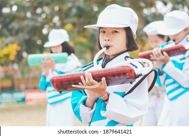 Kids Playing Music In Marching Band, Cute Asian Child Blowing Instrument On Sport Day In School