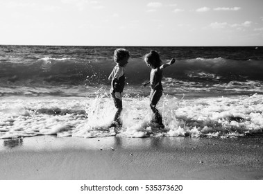 Kids Playing On The Beach At Sunset