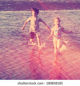 Kids playing on the beach in water - Instagram effect