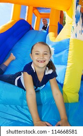 Kids playing on an inflatable slide bounce house