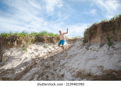 Kids Playing On The Sand Dunes At The Beach, Coffs Harbour Australia