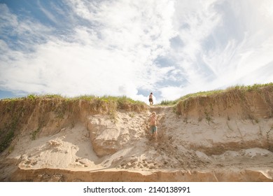 Kids Playing On The Sand Dunes At The Beach, Coffs Harbour Australia