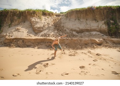 Kids Playing On The Sand Dunes At The Beach, Coffs Harbour Australia