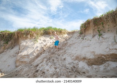 Kids Playing On The Sand Dunes At The Beach, Coffs Harbour Australia