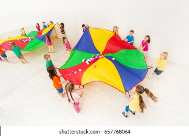 Kids Playing Parachute Games In Light Gym