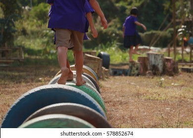 Kids playing in the playground. Running on tires.selective focus - Powered by Shutterstock