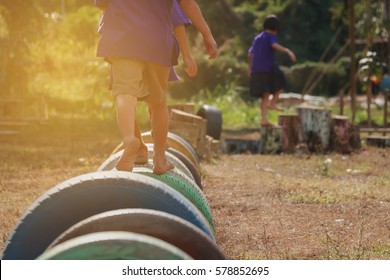 Kids Playing In The Playground. Running On Tires.selective Focus