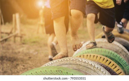 Kids Playing In The Playground. Running On Tires.selective Focus