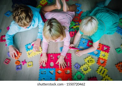 Kids Playing With Puzzle, Boy And Girl Learn Shapes And Numbers, Education Concept