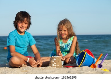 Kids Playing In The Sand - Building Castles Together On The Beach