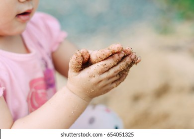 Kids playing in the sands. This activity is good for sensory experience and learning by touch their fingers and toes through sand and enjoying its texture.