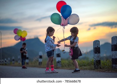 Kids Playing And Sharing Toys Balloons Together