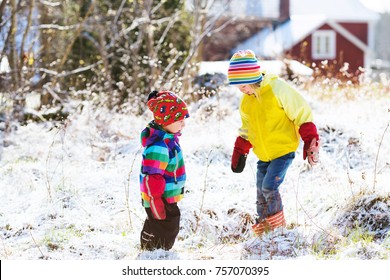 Kids Playing With Snow. Toddlers On Swedish Countryside. Girl And Boy On Cold Winter Snowy Day. Outdoors Family Vacation. First Snow In Rural Scandinavia. 