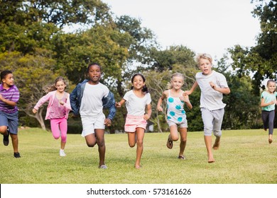 Kids Playing Together During A Sunny Day At Park