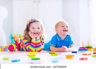 Kids Playing With Toys. Two Children, Cute Toddler Girl And Funny Baby Boy, Playing With Wooden Toy Blocks, Building Towers At Home Or Day Care. Educational Child Toys For Preschool And Kindergarten.