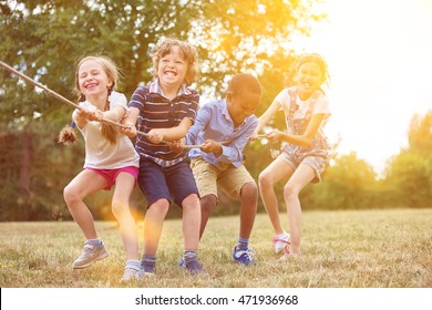 Kids playing tug of war at the park - Shutterstock ID 471936968