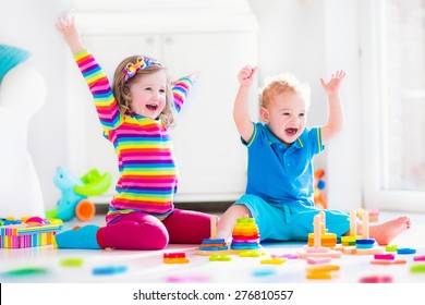 Kids Playing With Wooden Toys. Two Children, Cute Toddler Girl And Funny Baby Boy, Playing With Toy Blocks, Building Towers At Home Or Day Care. Educational Child Toys For Preschool And Kindergarten.