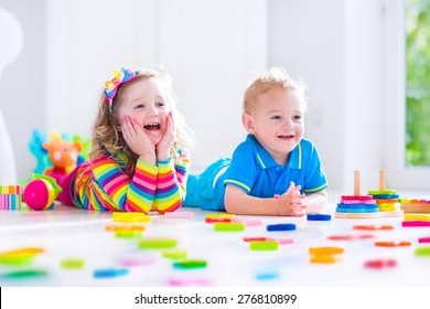 Kids Playing With Wooden Toys. Two Children, Cute Toddler Girl And Funny Baby Boy, Playing With Toy Blocks, Building Towers At Home Or Day Care. Educational Child Toys For Preschool And Kindergarten.