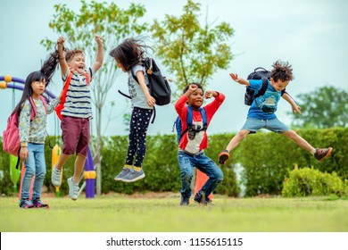 Kids Preschool Kindergarten Enjoy And Happy Jumping On The Field Of Playground After School Class Is Over To Retuning Home