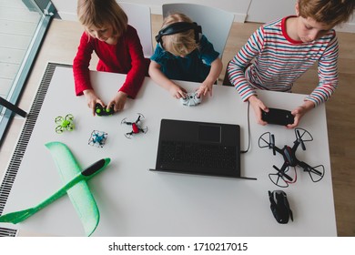 kids programming planes and drones, boy and girls with remote controls and laptop